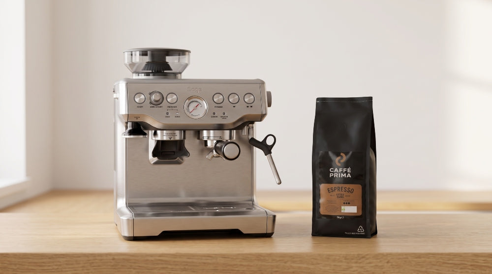 Sage Barista Express pulling an espresso shot with a bag of Caffé Prima beans beside it