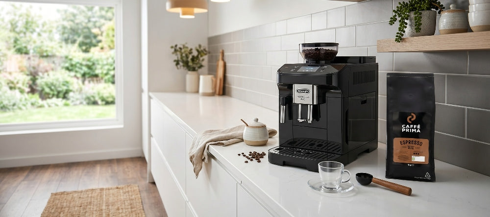 Caffe Prima Espresso Blend bag next to the The De'Longhi Magnifica Evo on a kitchen top of a modern kitchen