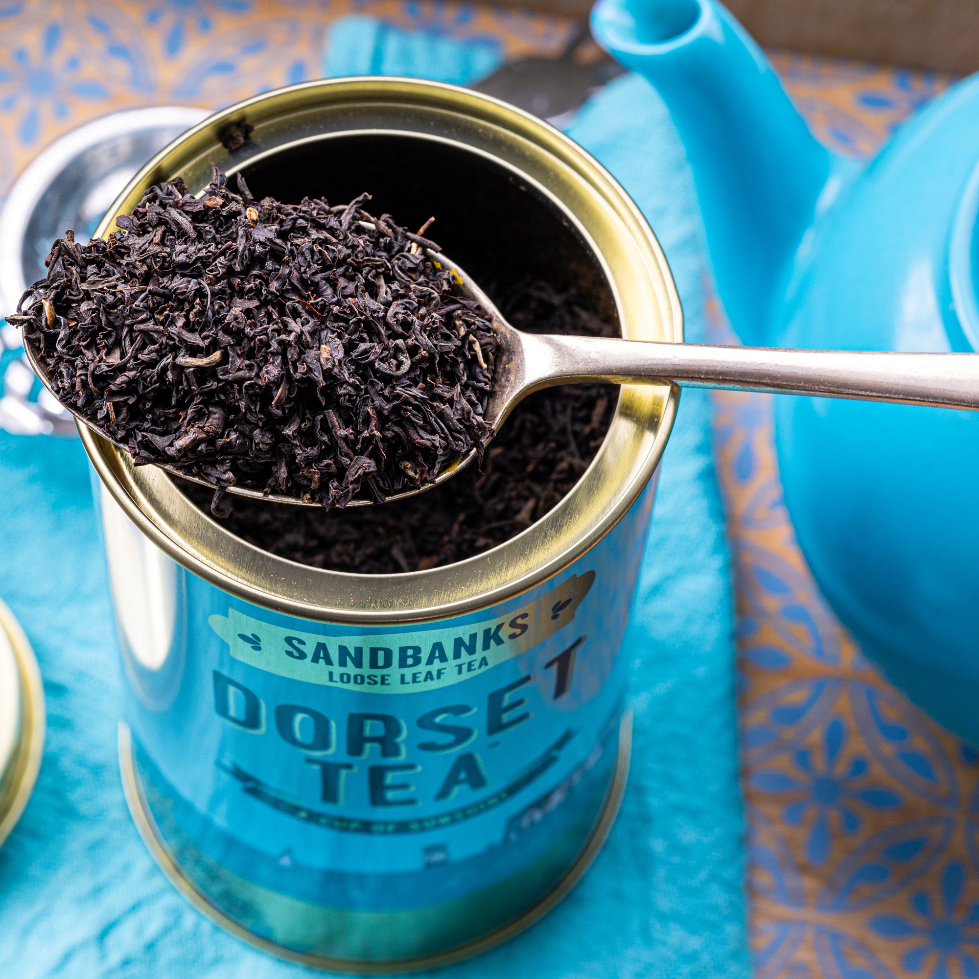 Close-up of black loose leaf tea leaves in a container.